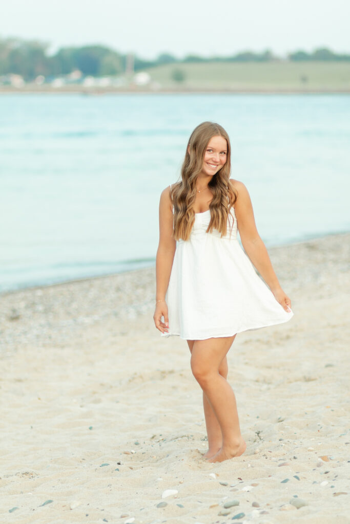 senior girl posing on the beach for her senior photos