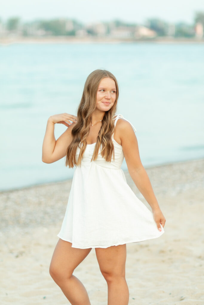 senior girl posing on the beach for her senior photos